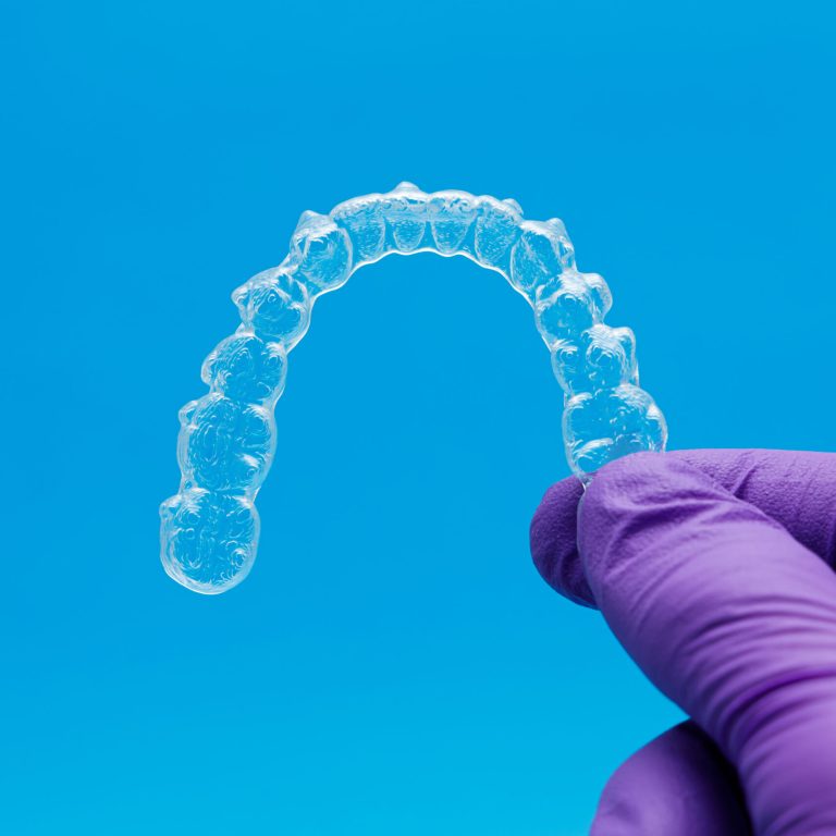 hand-with-gloves-holding-one-transparent-retainer-2024-11-25-21-52-28-utc